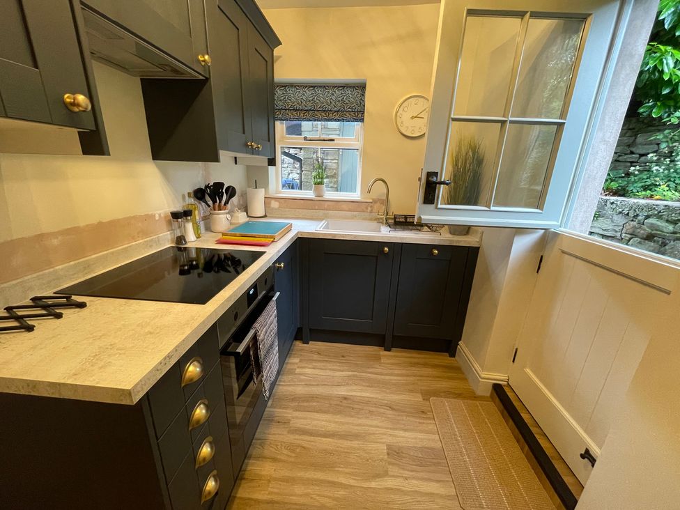 A kitchen with cabinets, sink, and stove at 3 Chapel Square Brookhouse near Caton