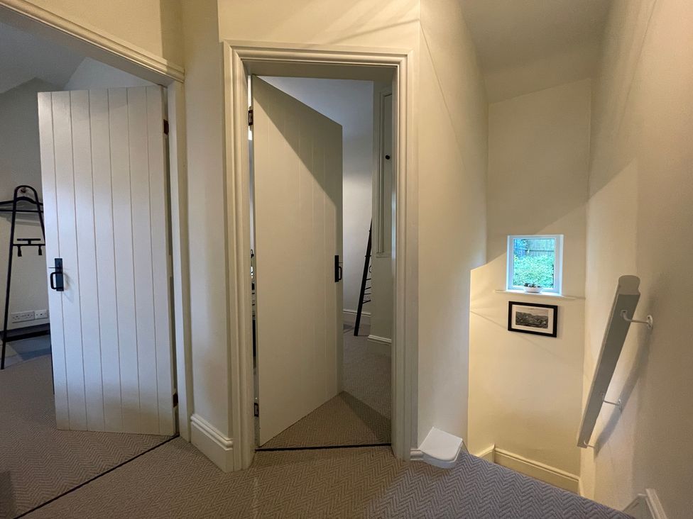 A hallway with doors and a window at 3 Chapel Square Brookhouse near Caton