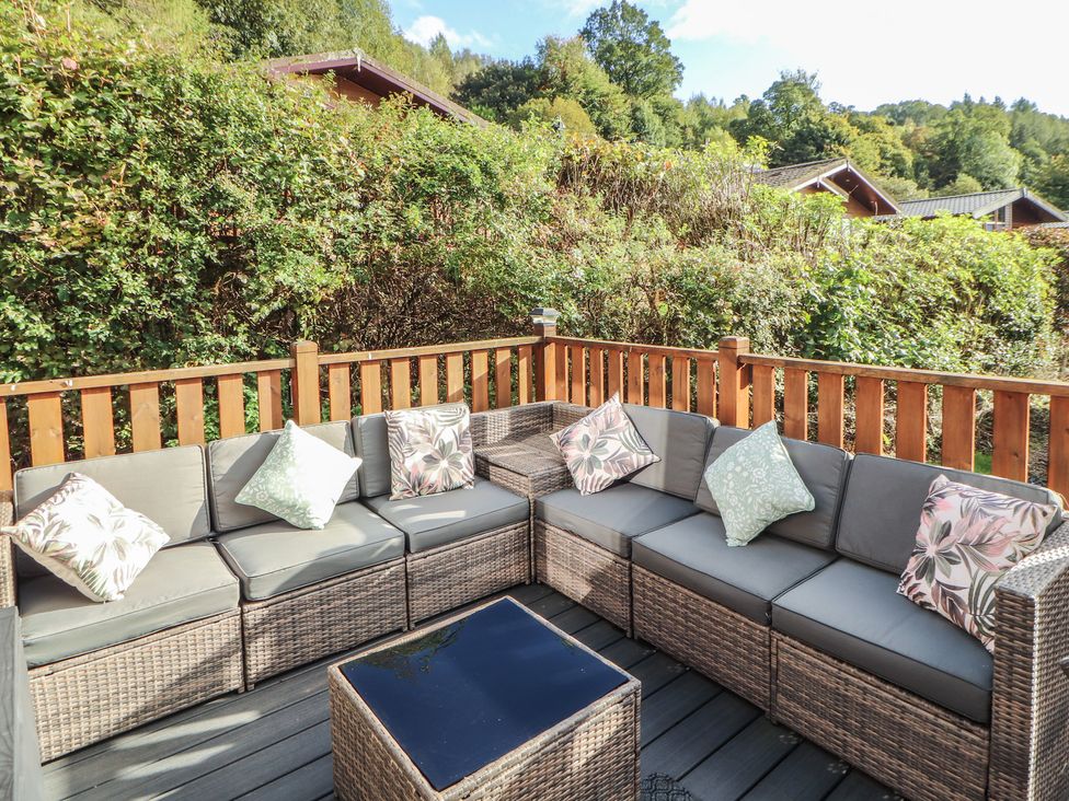 An outdoor seating area with a sofa and table at Swifts Reach Lodge Kirkstone 10 Limefitt Park near Windermere