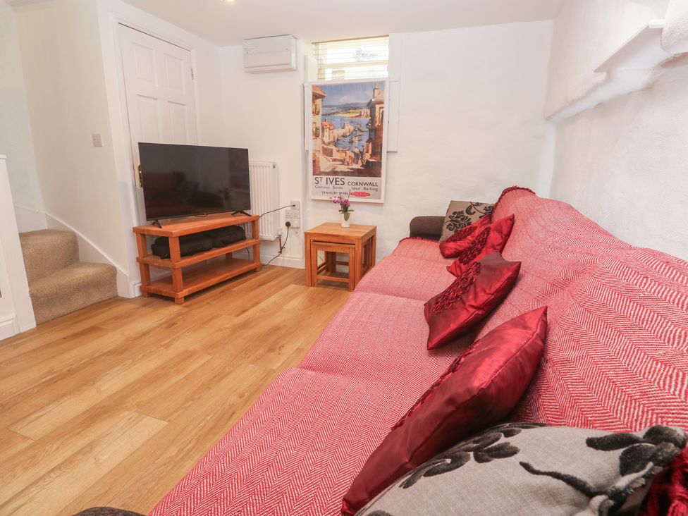 A living room with a television and sofa at 23 Carncrows Street St Ives