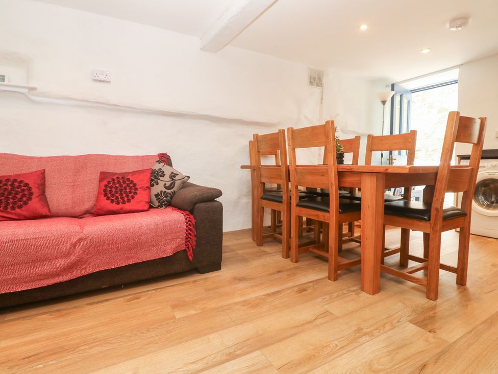 A dining room with a sofa and dining table at 23 Carncrows Street St Ives