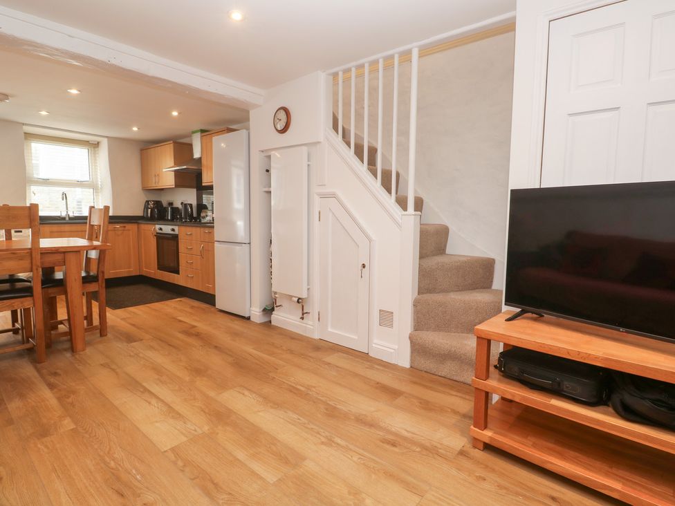 A kitchen with a dining table and chairs at 23 Carncrows Street St Ives