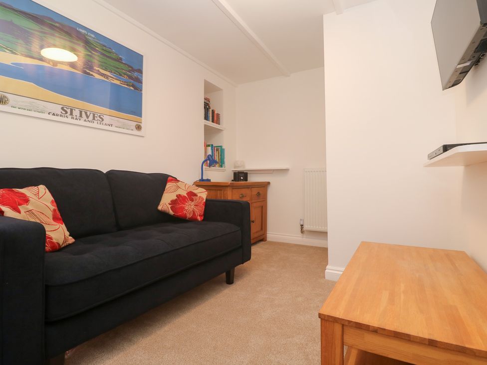 A snug with a sofa and television at 23 Carncrows Street in St Ives