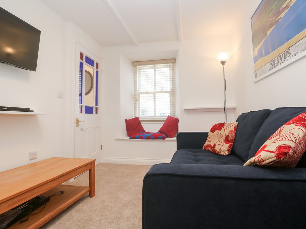 A living room with a television and sofa at 23 Carncrows Street St Ives