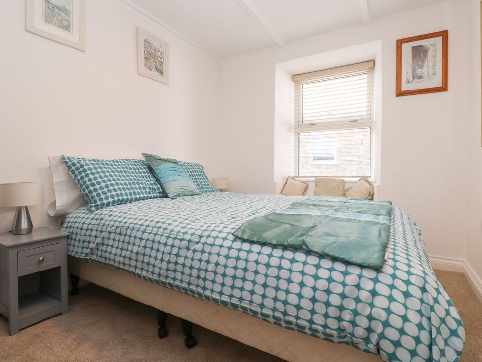 A bedroom with a bed and nightstand at 23 Carncrows Street St Ives