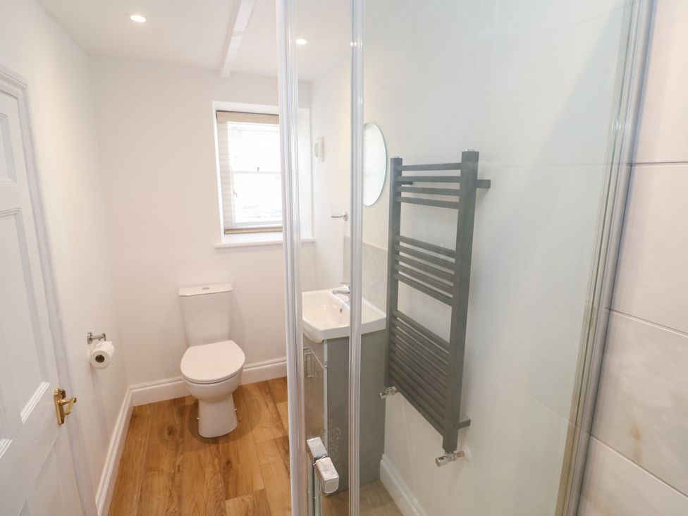A bathroom with a shower, sink, and toilet at 23 Carncrows Street St Ives