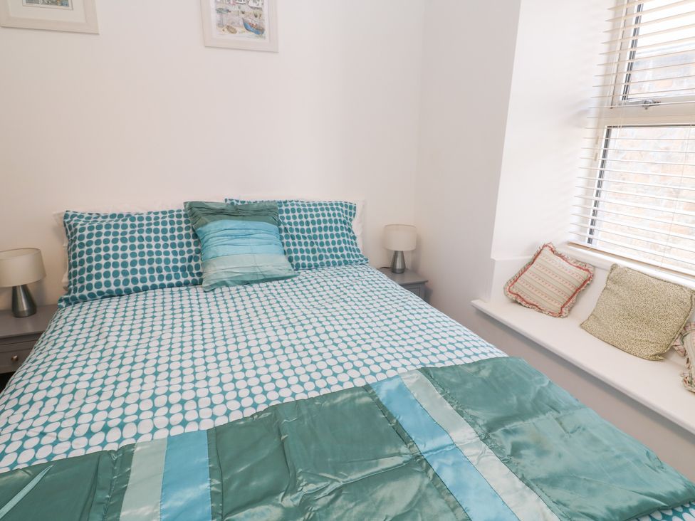 A bedroom with a bed and pillows at 23 Carncrows Street St Ives