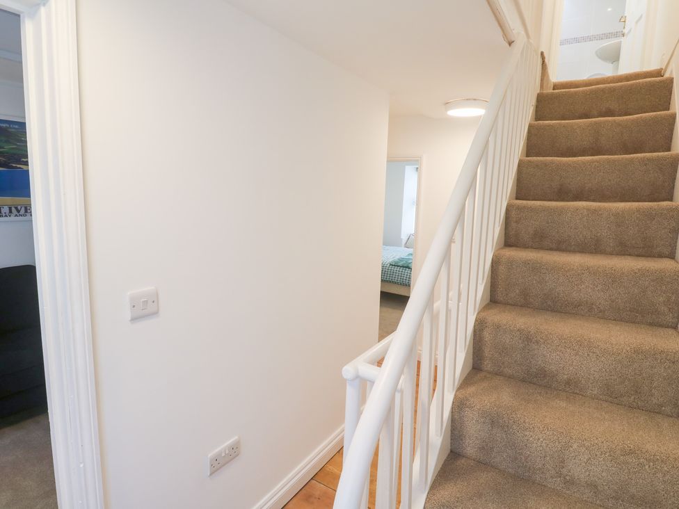 A hallway with a staircase and doors at 23 Carncrows Street St Ives