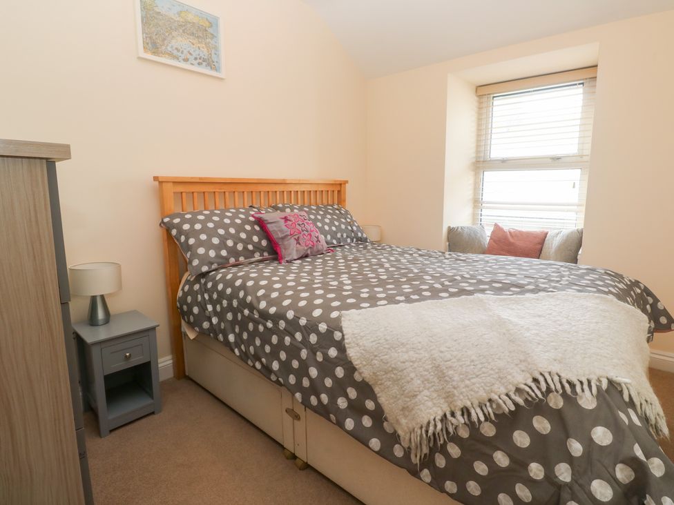A bedroom with a bed and nightstand at 23 Carncrows Street St Ives