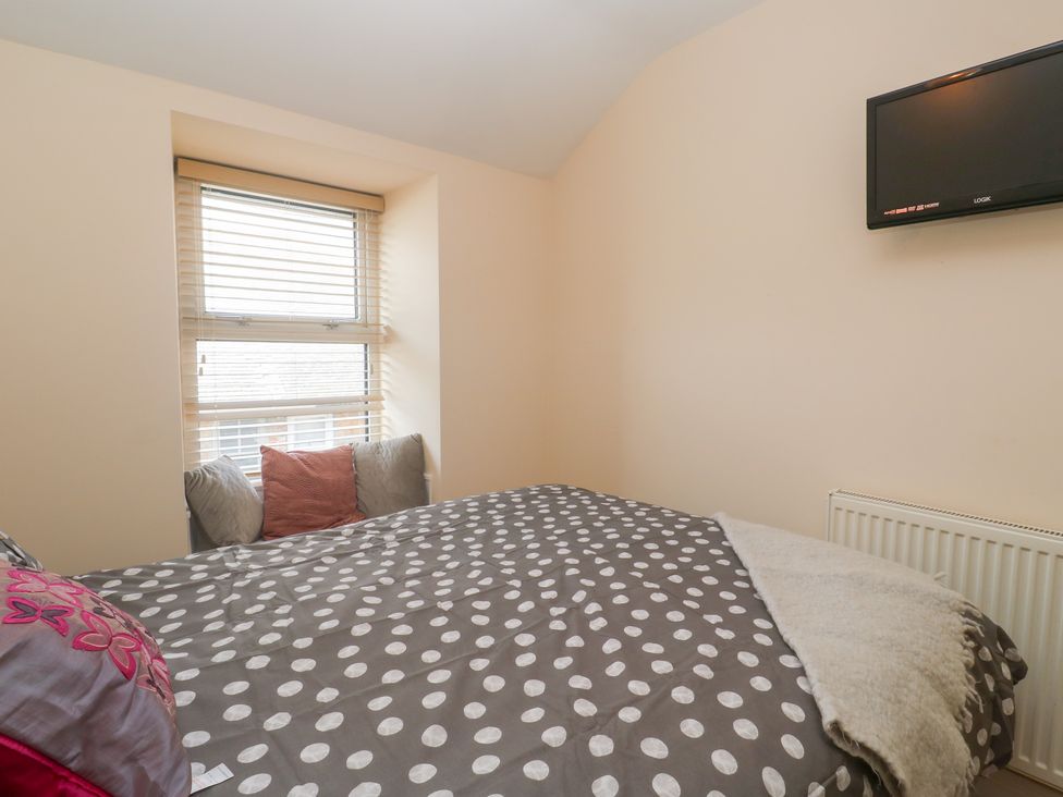 A bedroom with a bed and a television at 23 Carncrows Street St Ives