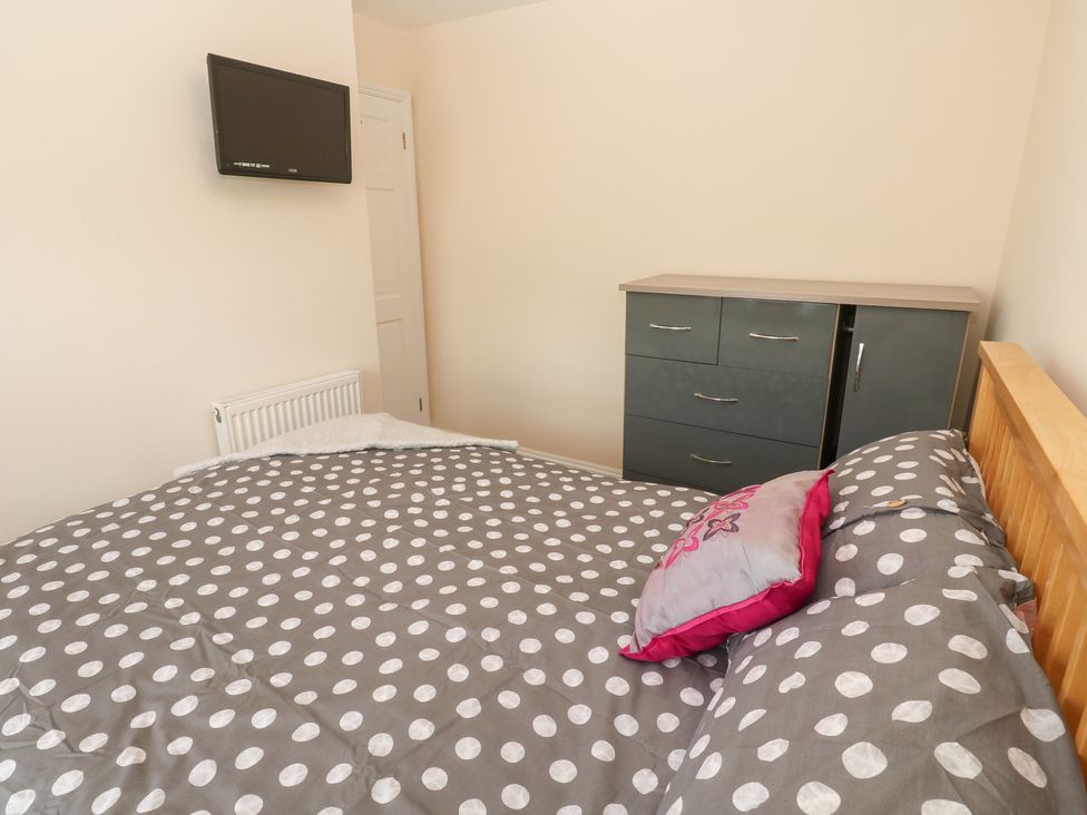 A bedroom with a bed and television at 23 Carncrows Street St Ives