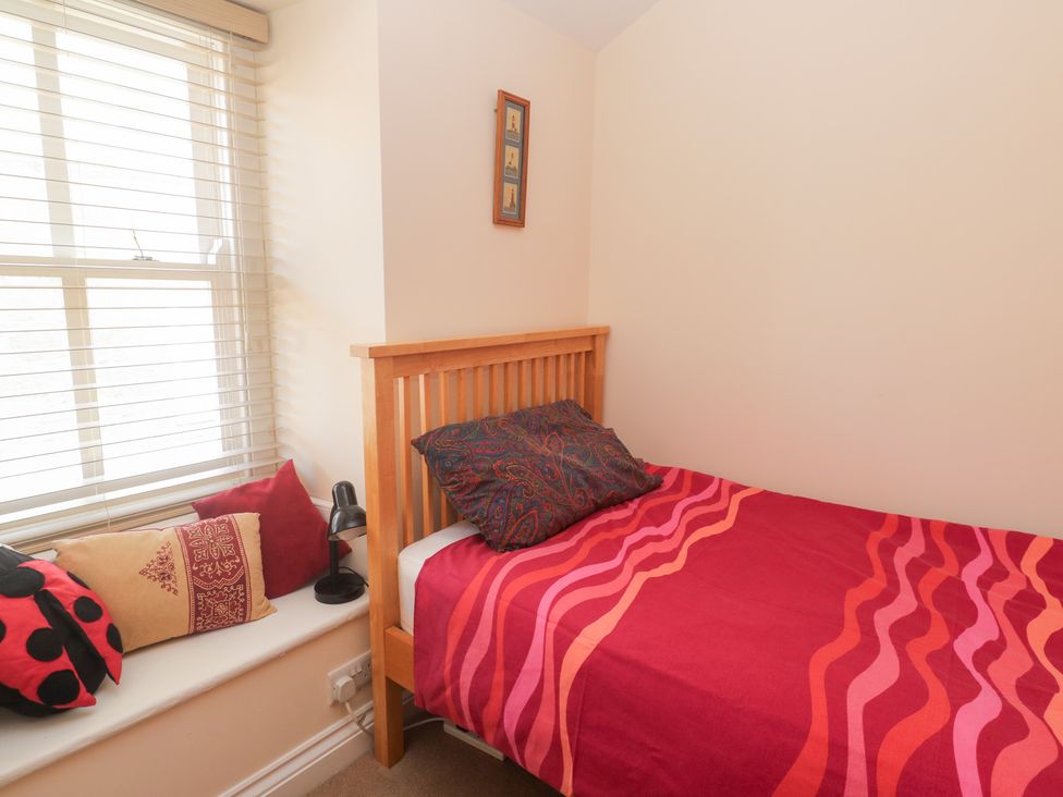 A bedroom with a bed and pillows at 23 Carncrows Street St Ives