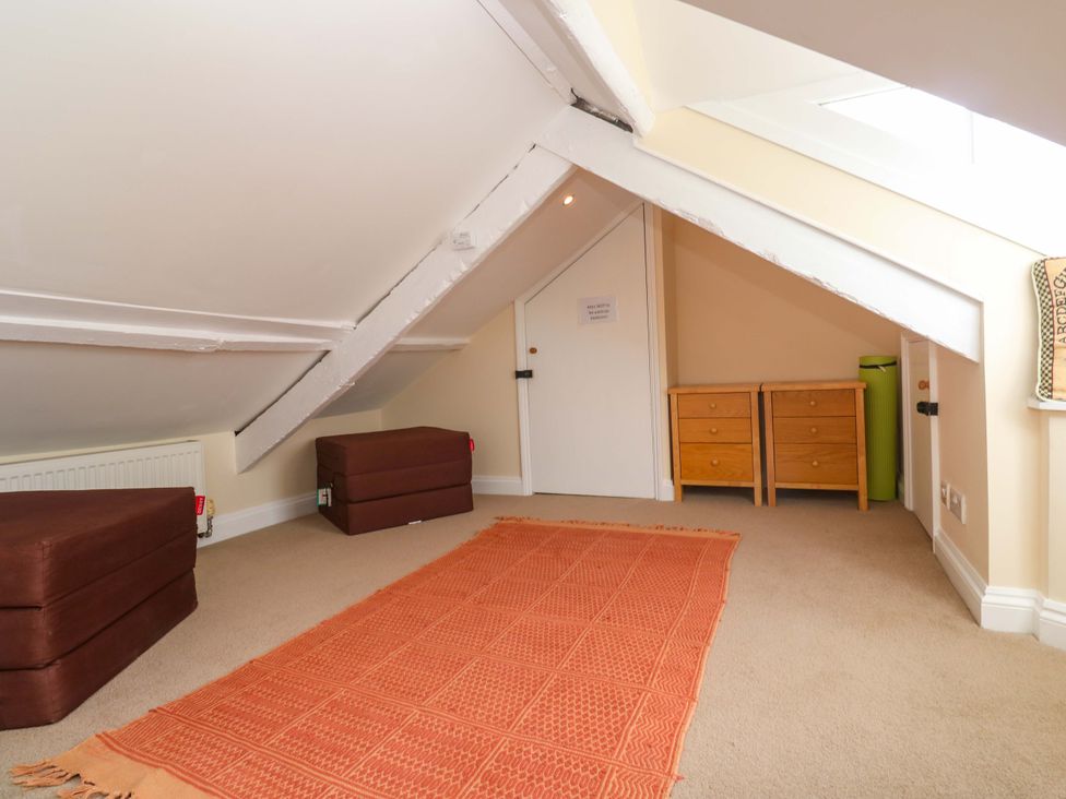 A loft area with storage boxes and wooden drawers at Rockpools, 23 Carncrows Street St Ives