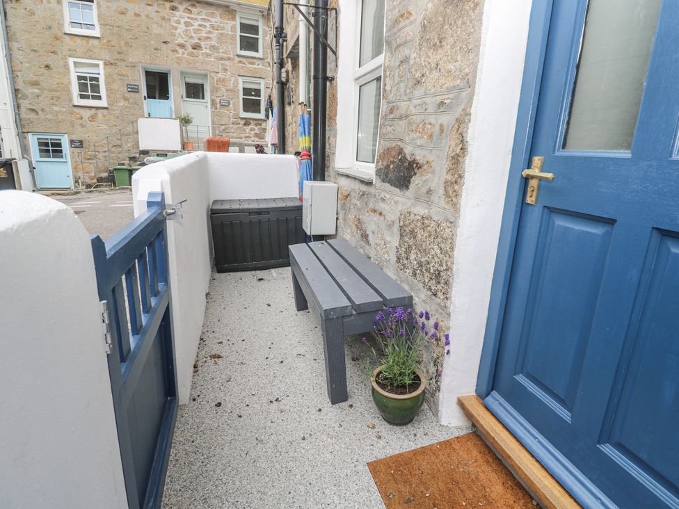 An outdoor area with a bench and plant pot at Rockpools, 23 Carncrows Street St Ives