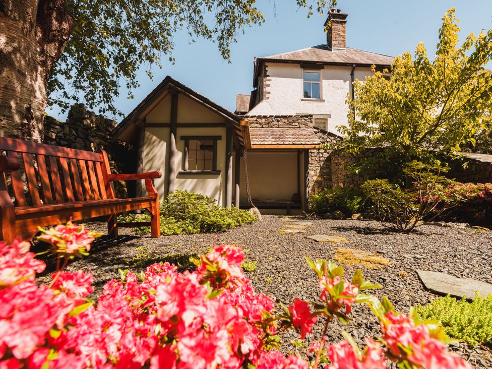 A garden with a bench and flowers at Leathes Head Country House Borrowdale near Keswick