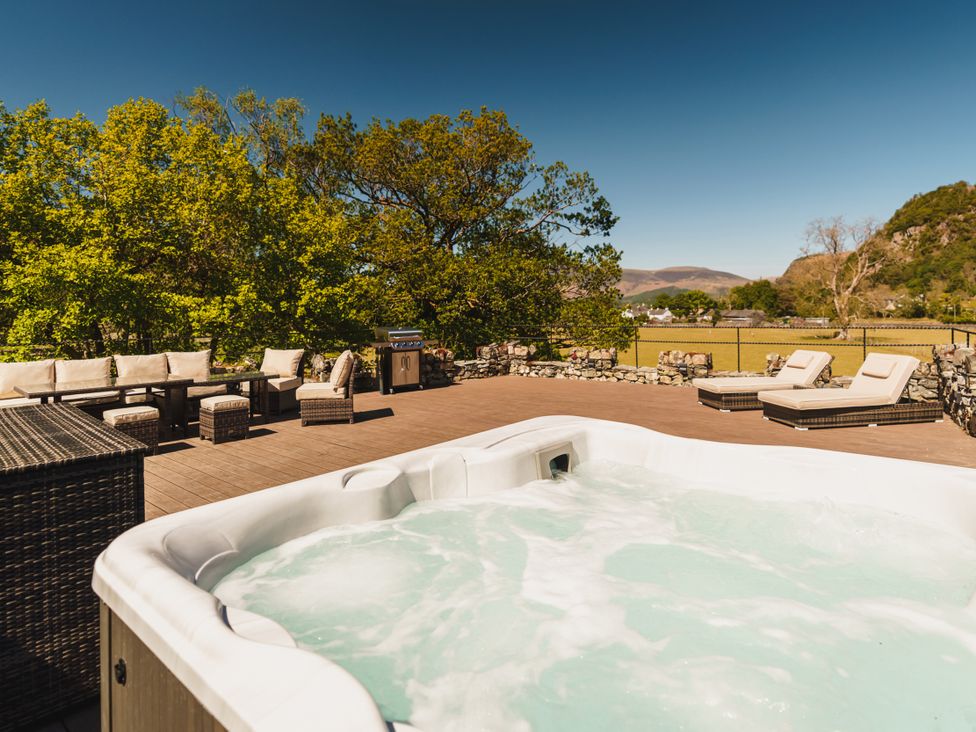 An outdoor space with a hot tub and seating area at Leathes Head Country House in Borrowdale near Keswick