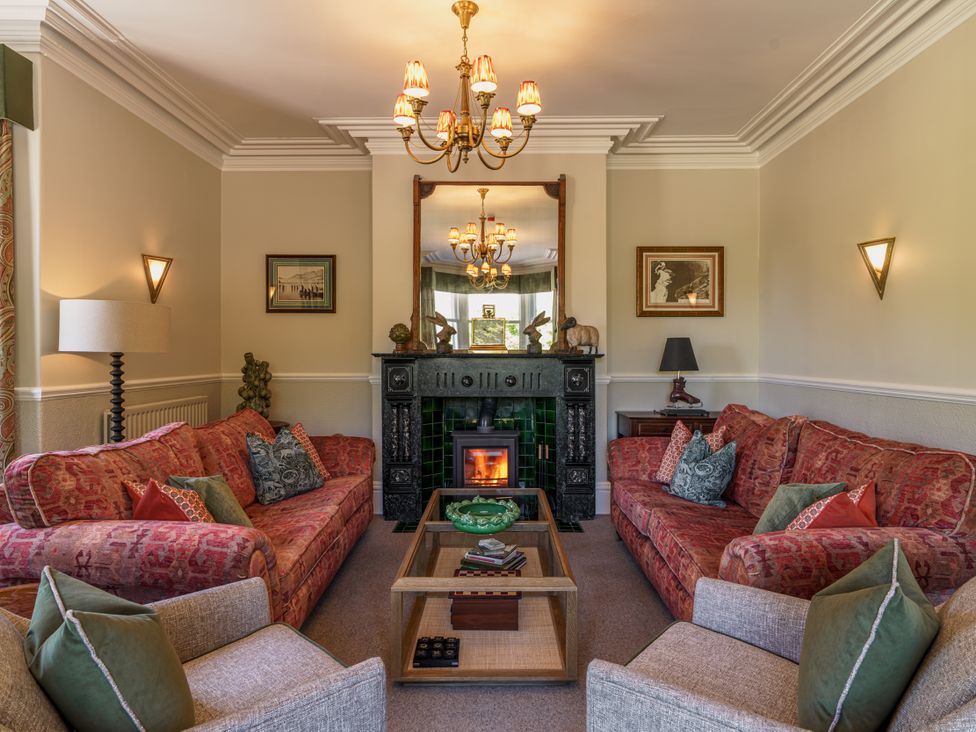 A living room with sofas and a fireplace at Leathes Head Country House in Borrowdale near Keswick