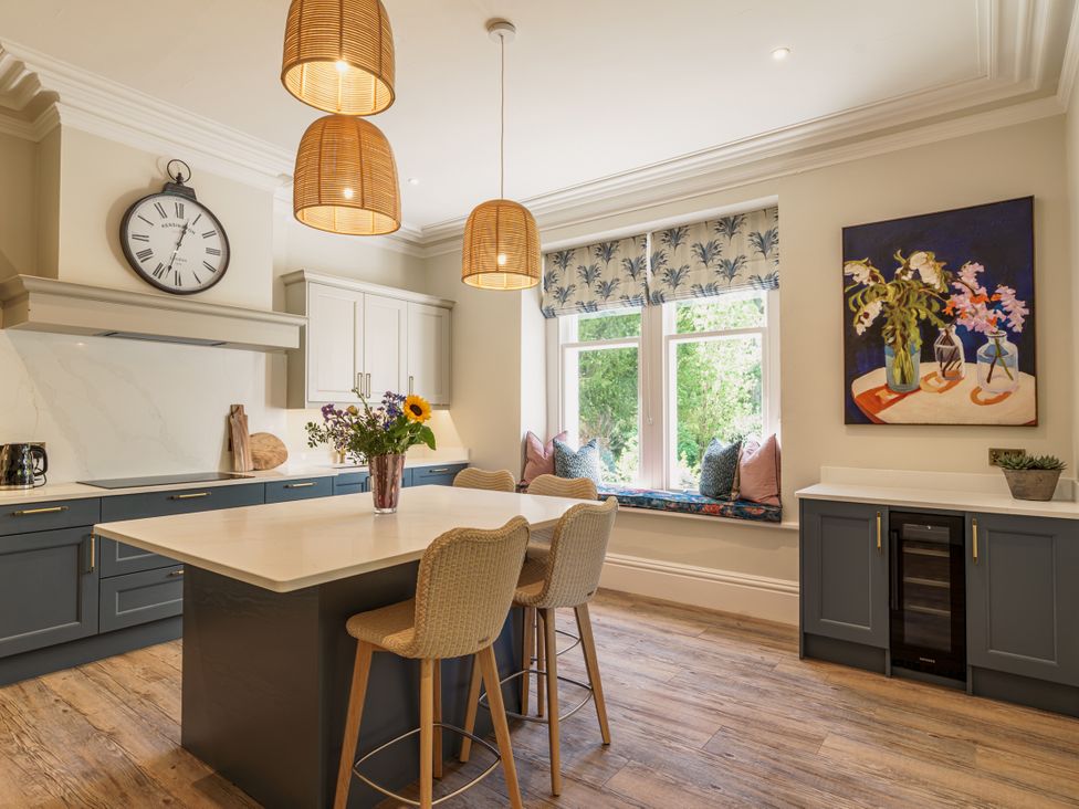 A kitchen with an island and seating at Leathes Head Country House Borrowdale near Keswick
