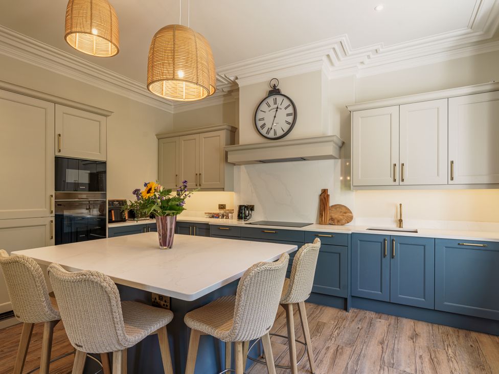 A kitchen with a countertop and stools at Leathes Head Country House, Borrowdale near Keswick