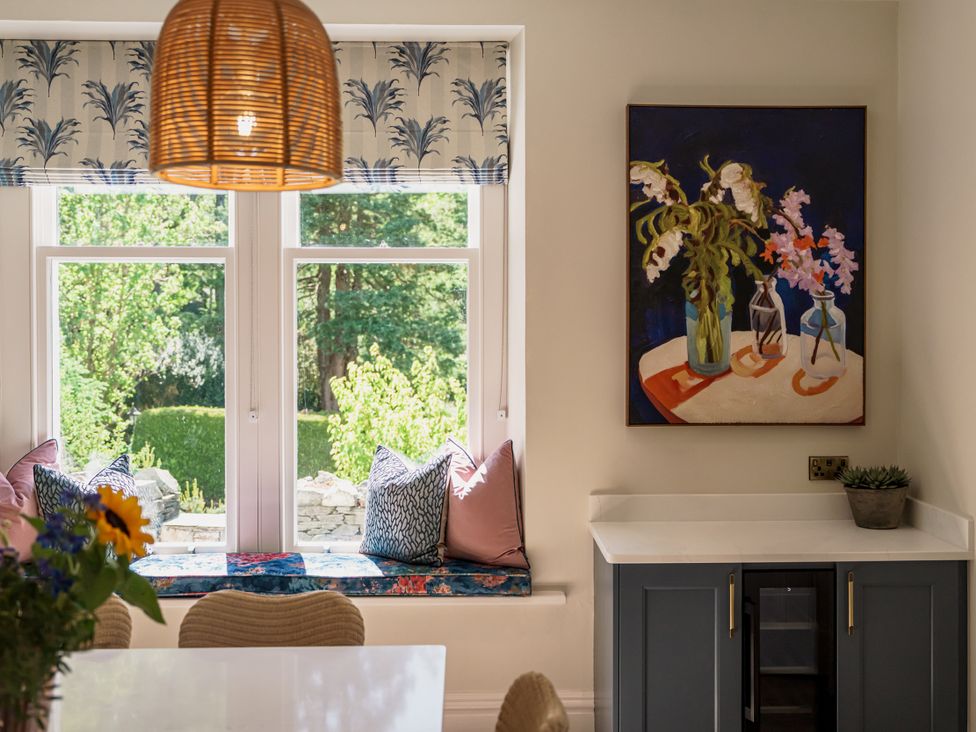 A kitchen with cushions on a bench and a painting on the wall at Leathes Head Country House Borrowdale near Keswick