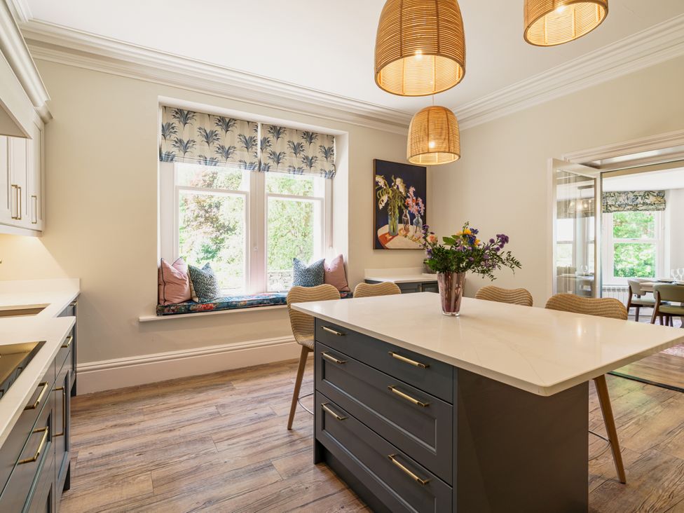 A kitchen with a counter, cabinets and window at Leathes Head Country House Borrowdale near Keswick