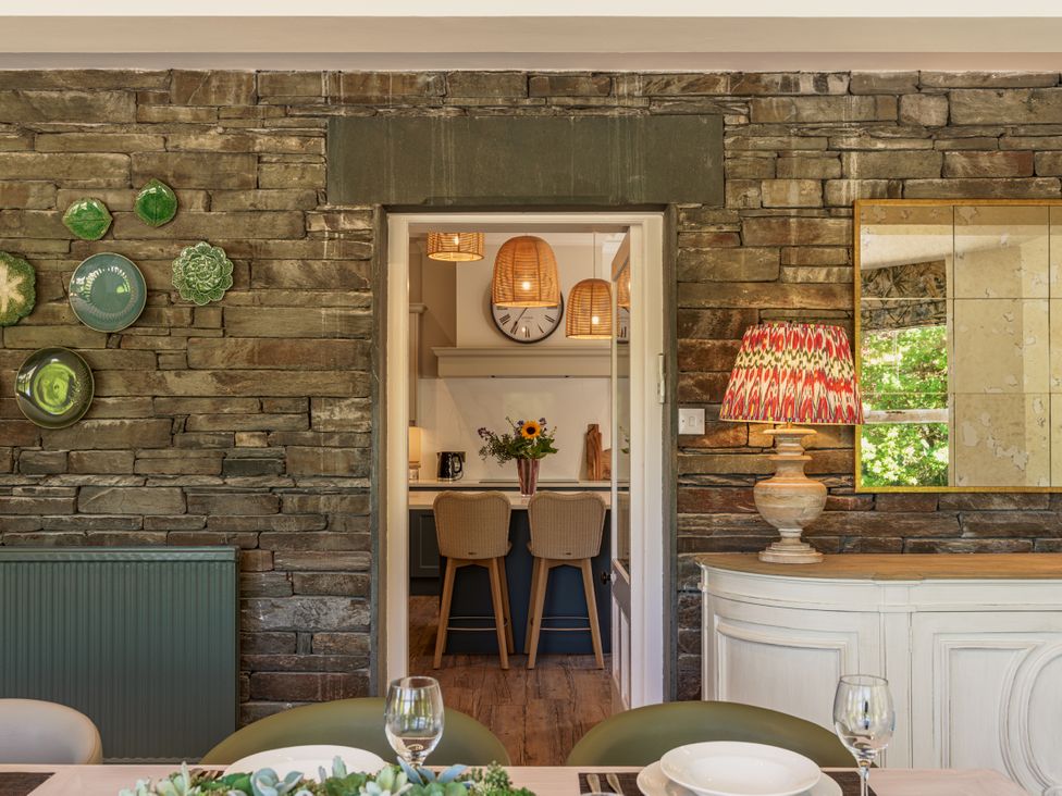 A dining room with a view into the kitchen at Leathes Head Country House Borrowdale near Keswick