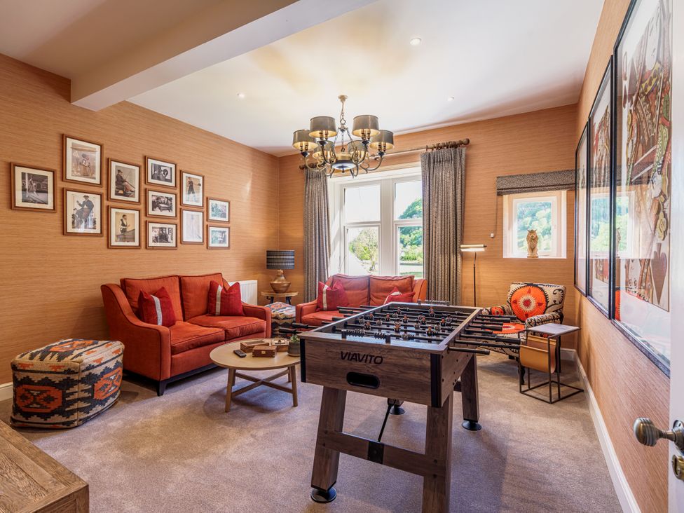 A living room with a foosball table and seating area at Leathes Head Country House in Borrowdale near Keswick