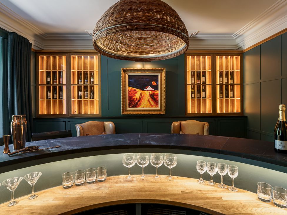 A bar area with bottles and glasses at Leathes Head Country House in Borrowdale near Keswick