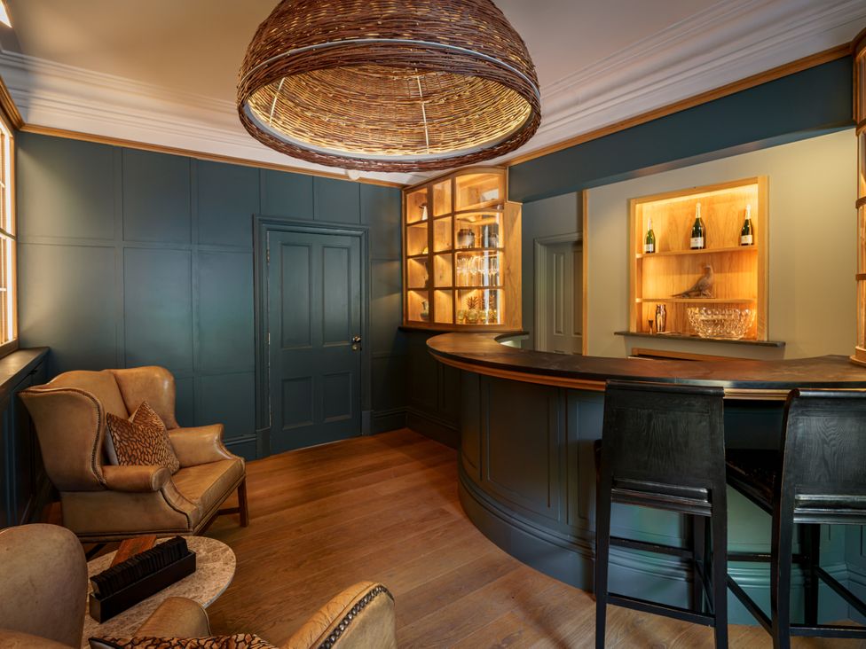 A bar area with shelves and seating at Leathes Head Country House Borrowdale near Keswick