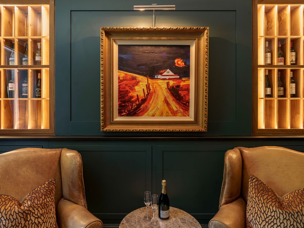 A lounge with a painting and wine bottles at Leathes Head Country House Borrowdale near Keswick