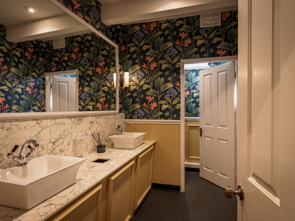 A bathroom with sinks and mirrors at Leathes Head Country House Borrowdale near Keswick