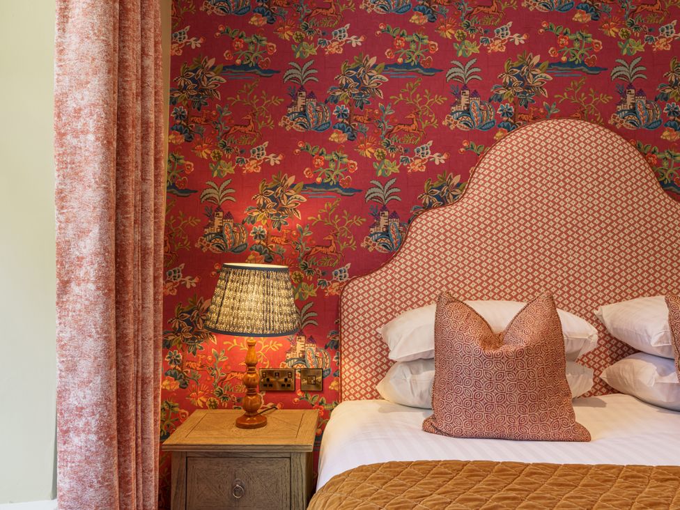A bedroom with a bed, pillows, and a lamp at Leathes Head Country House Borrowdale near Keswick
