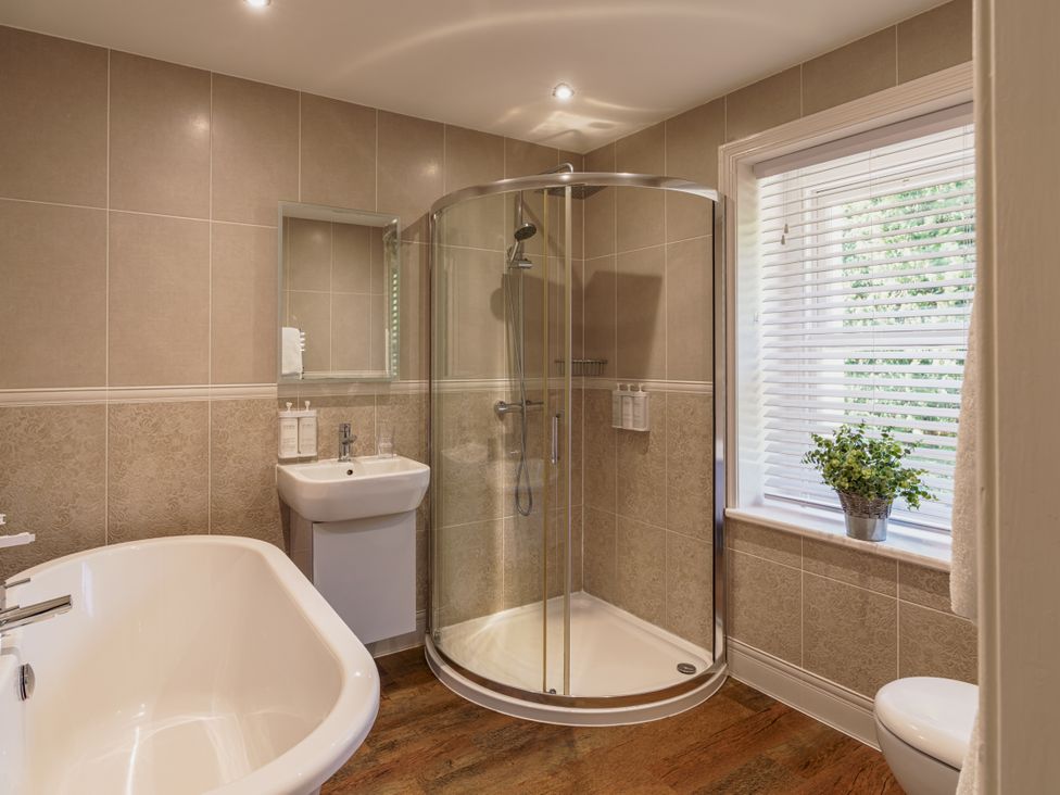 A bathroom with a shower and bathtub at Leathes Head Country House Borrowdale near Keswick