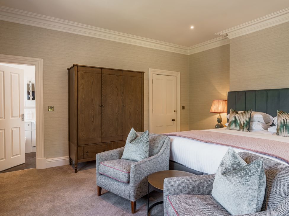 A bedroom with a bed and wardrobe at Leathes Head Country House Borrowdale near Keswick