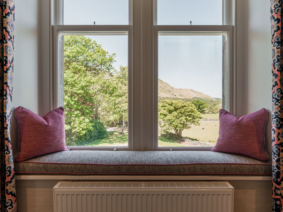 A sitting room with a window seat and view at Leathes Head Country House Borrowdale near Keswick