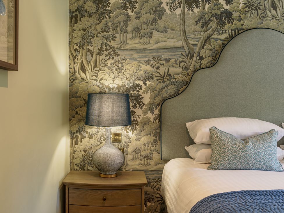 A bedroom with a bed and lamp at Leathes Head Country House Borrowdale near Keswick