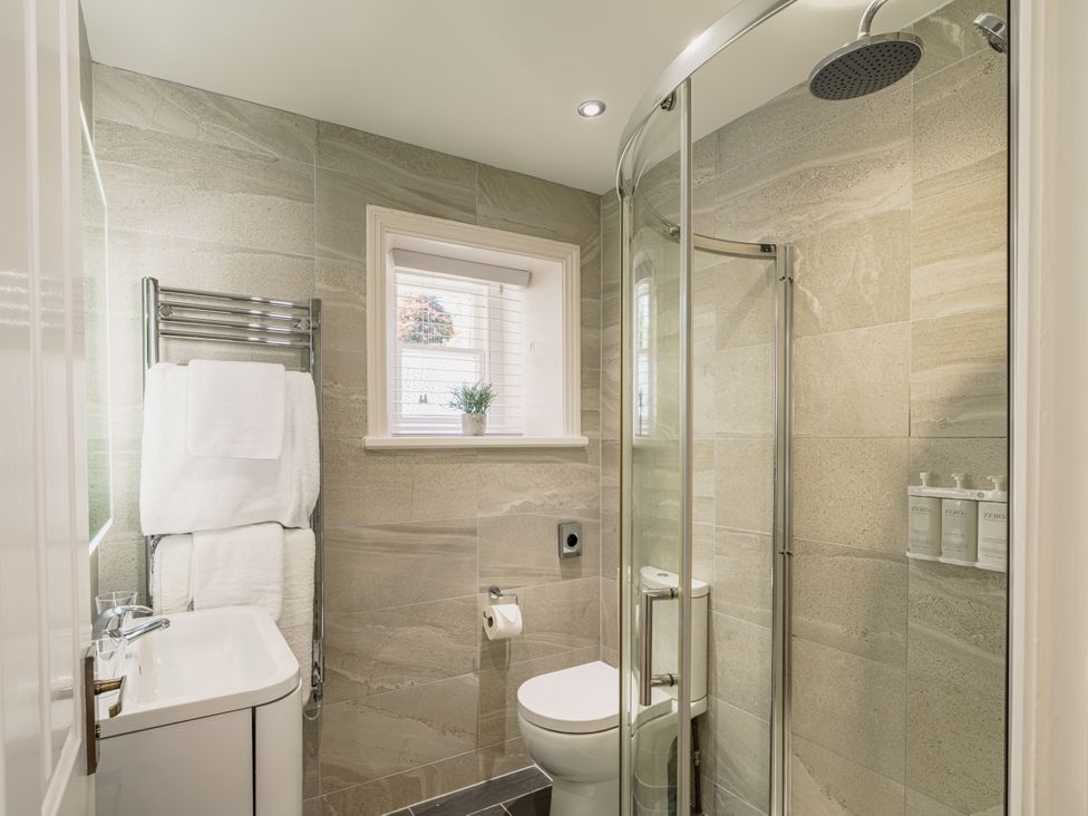 A bathroom with shower, toilet, and sink at Leathes Head Country House in Borrowdale near Keswick