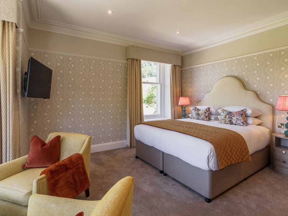 A bedroom with a bed and television at Leathes Head Country House in Borrowdale near Keswick