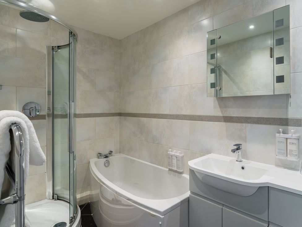 A bathroom with a shower, bathtub, and sink at Leathes Head Country House Borrowdale near Keswick