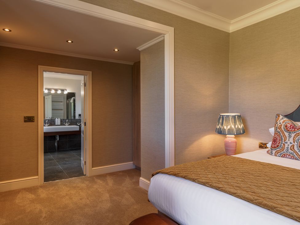 A bedroom with a doorway leading to a bathroom at Leathes Head Country House in Borrowdale near Keswick