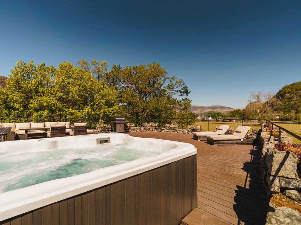 An outdoor area with a hot tub and lounge chairs at Leathes Head Country House in Borrowdale near Keswick