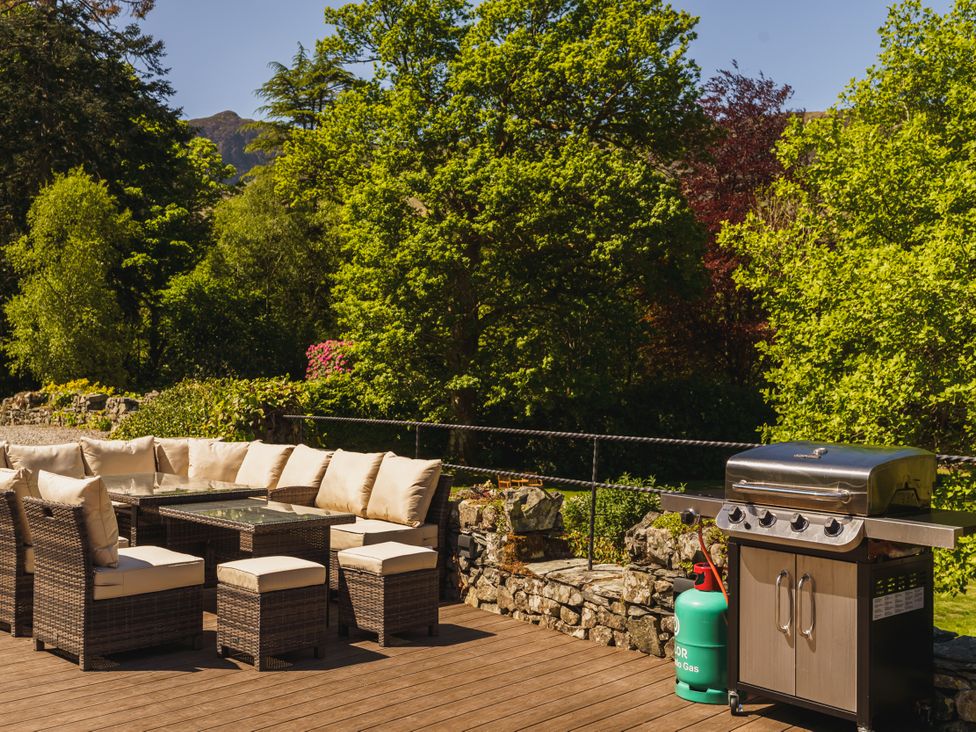 An outdoor seating area with a barbecue grill at Leathes Head Country House in Borrowdale near Keswick