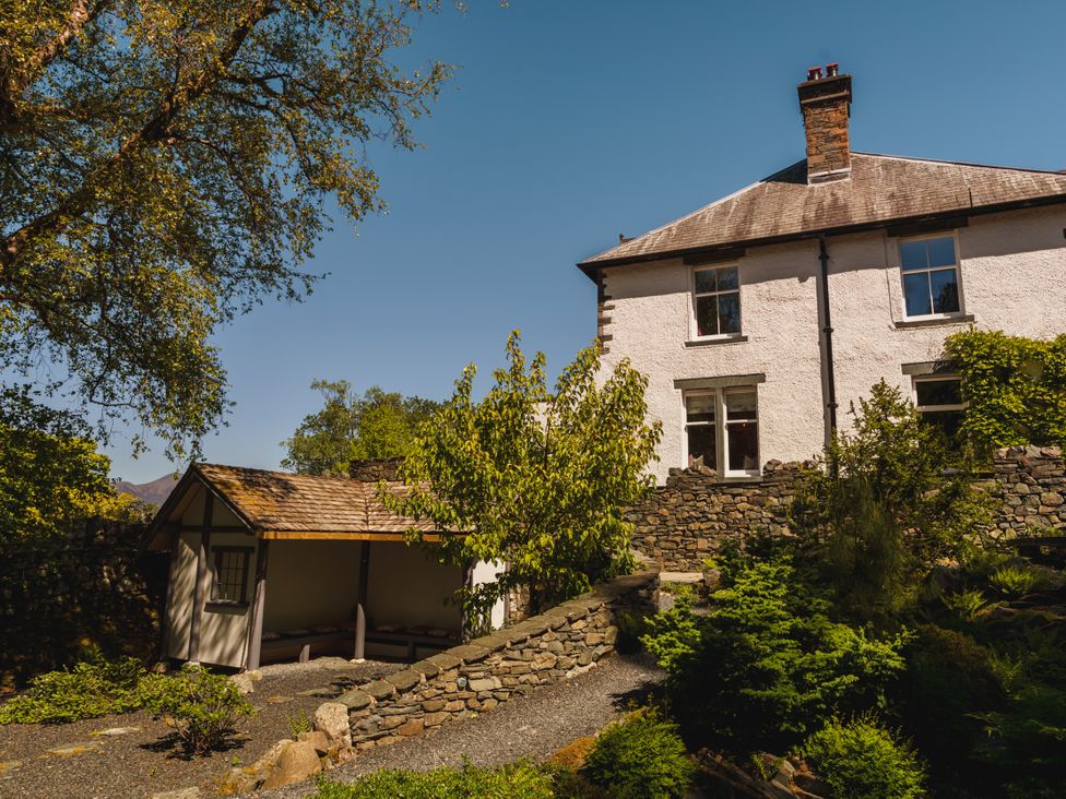 A house with a garden and stone wall at Leathes Head Country House Borrowdale near Keswick