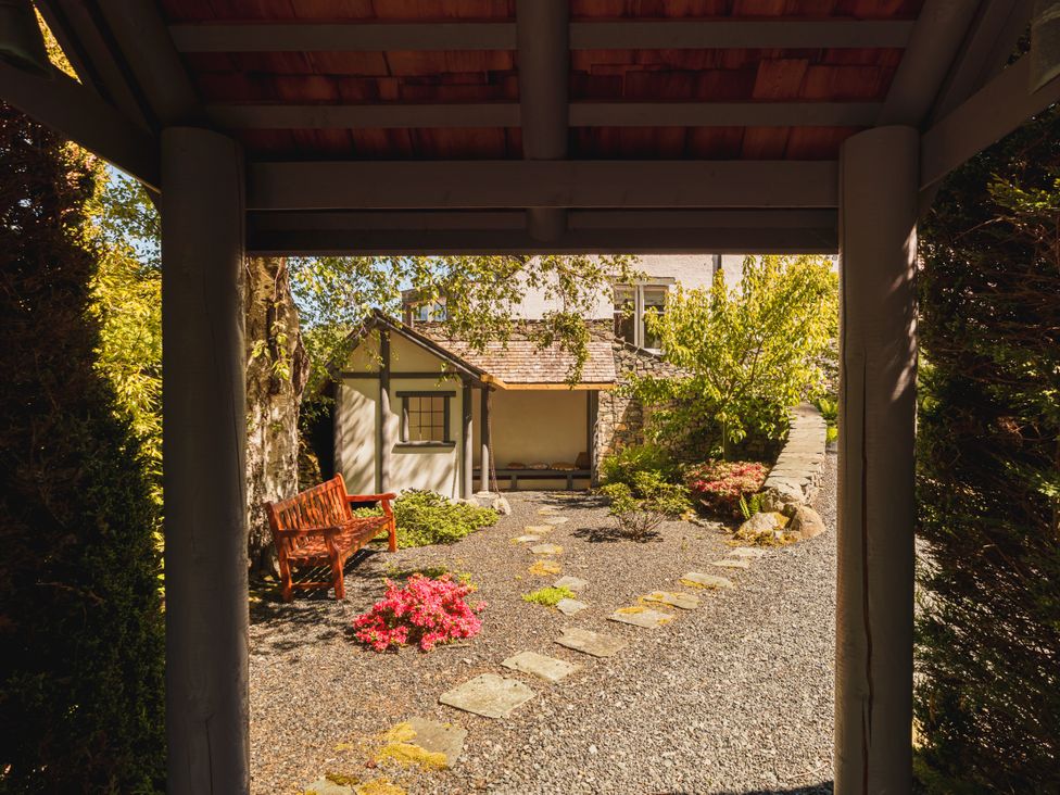 A garden with a bench and gravel path at Leathes Head Country House Borrowdale near Keswick