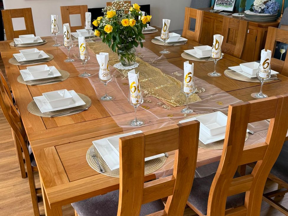A dining room with a table set for a celebration at Crossett Grange in Driffield