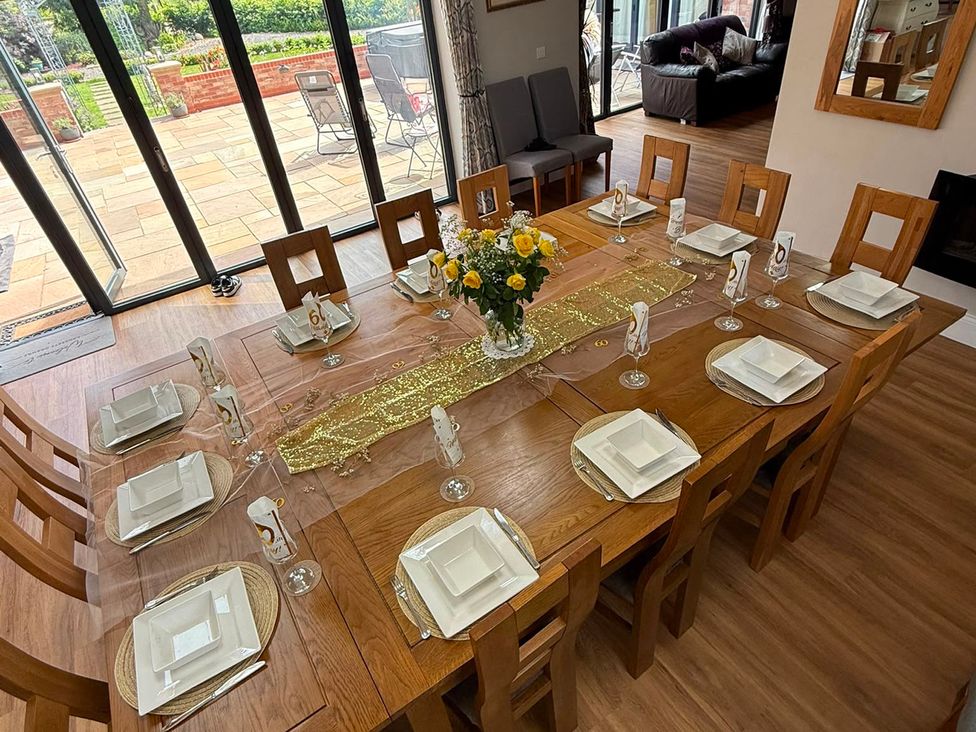 A dining room with a table set for a meal at Crossett Grange in Driffield