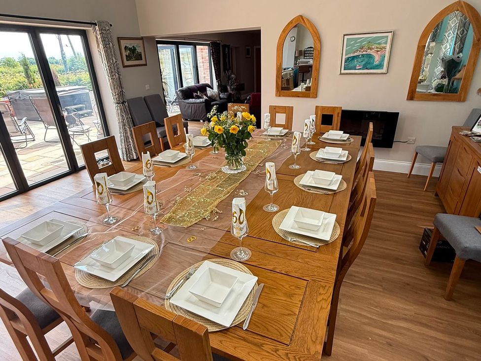 A dining room with a table set for a meal at Crossett Grange in Driffield