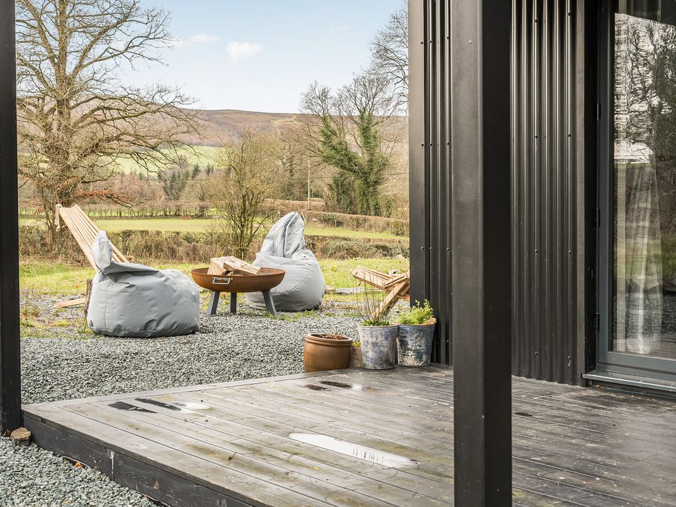 An outdoor area with bean bags and a fire pit at Grove Cottage Kington