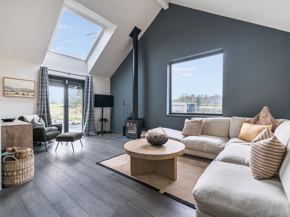 A living room with a sofa and coffee table at Grove Cottage in Kington