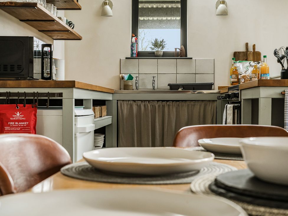 A kitchen with sink and stove at Grove Cottage in Kington